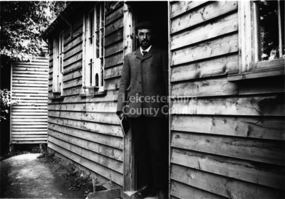 L2264 - A man at the doorway of an office building at Wotton Underwood