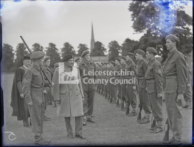 Officer inspecting line of soldiers/cadets	