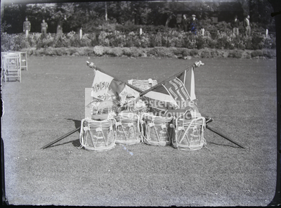 Display of drums and flags on grass 