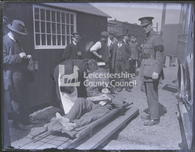 Nurse attending to wounded man on stretcher