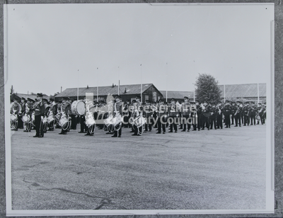 Large marching band standing in military yard	