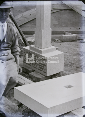 Mason next to pillar memorial stone