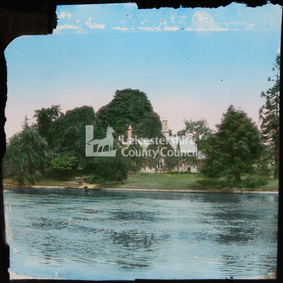 View of house in trees by river	