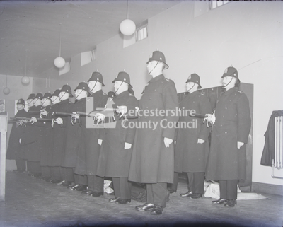 Line of constables standing inside building	