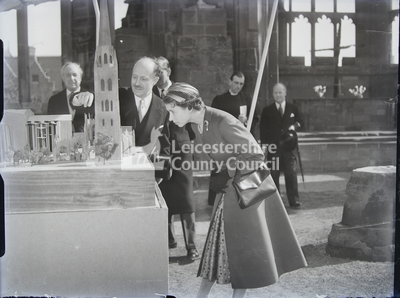 Royal Visit To Coventry Cathedral- Queen Looking At Architectural Model