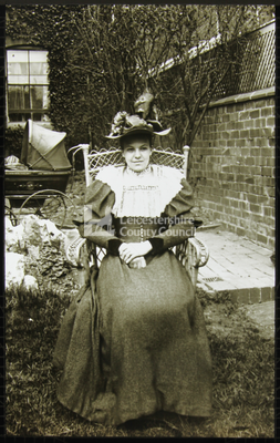 A young lady posing in a garden		