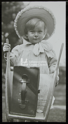 Boy holding a wheelbarrow
