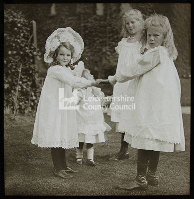 Four children playing ring of roses		