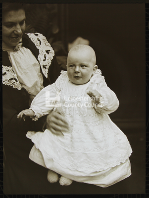 Lady holding a small baby		