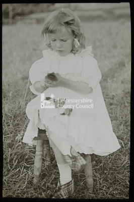 Girl sitting on chair in the fields	