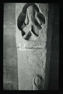 Pillar with worn sculpture