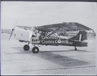 Auster aeroplane on tarmac, registration XK 410