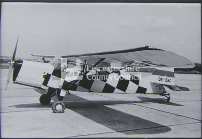 Auster aircraft with chequered design on tarmac
