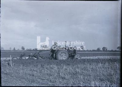 Woman operating tractor plough