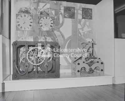 Various pieces of clockwork in display case