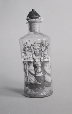 Folk Art	-  Clear glass bottle with figurines inside		