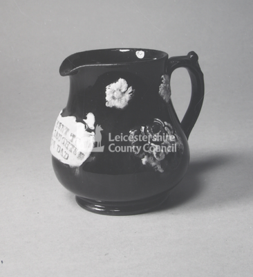 Enamelled dark single-handled jug
