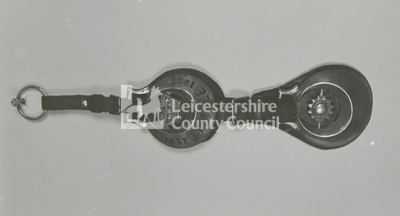 leather attachment with 2 horse brasses (jubilee crown in crescent, star in crescent)			