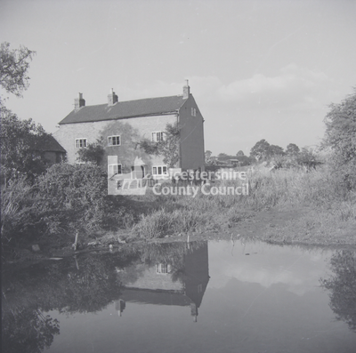 Large gabled brick-built house and pond