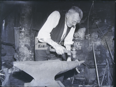 Blacksmith Working Horseshoe On An Anvil