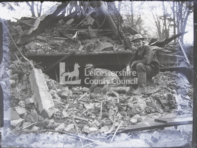 Two uniformed men crawling in rubble