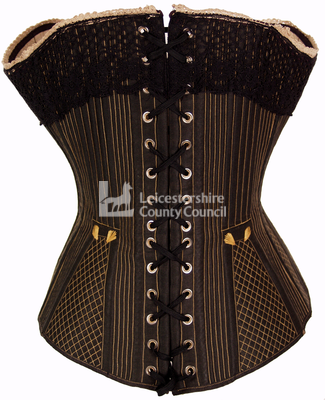 Black front busk corset, 1875: Back view