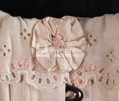 White long skirted corset, 1918: Detail of bow
